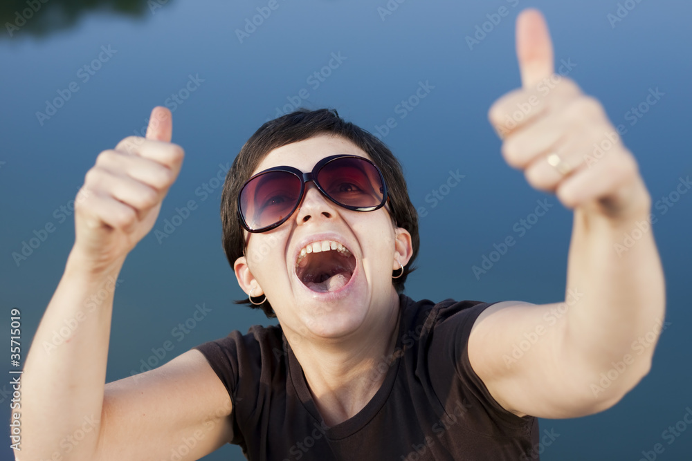 Young brunette girl making thumbs up gesture Young brunette girl making thumbs up gesture