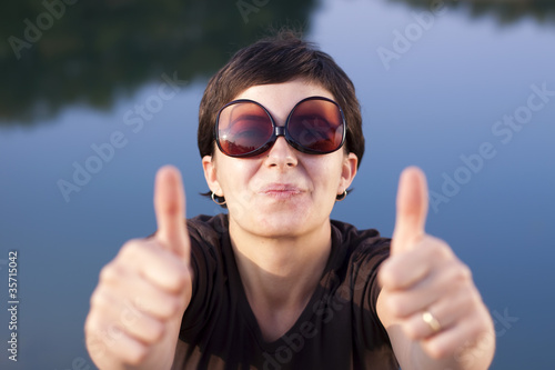 Young brunette girl making thumbs up gesture
