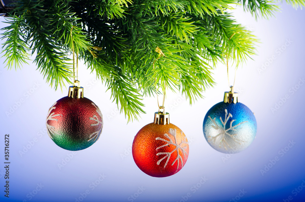 Baubles on christmas tree in celebration concept Baubles on christmas tree in celebration concept
