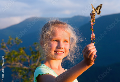 girl and butterfly in sunset mountain © wildman