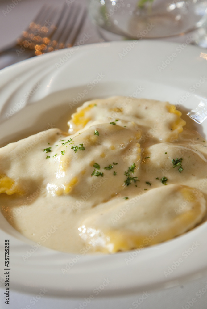 Delicious ravioli with cheese sauce