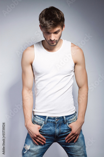 young beautiful man in white t-shirt posing © mast3r