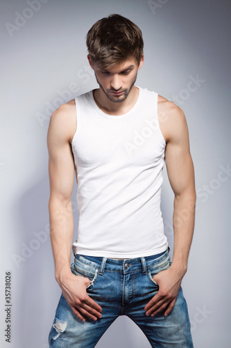 young beautiful man in white t-shirt posing