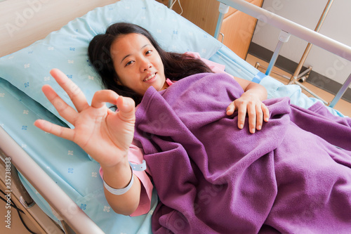 Female patient sowing cheerful ok hand sign