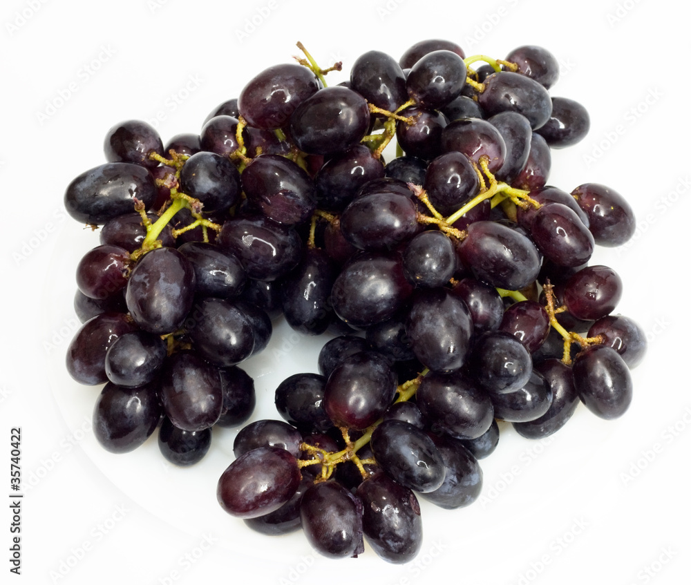 Bunch of black grapes isolated on white background Bunch of black grapes isolated on white background