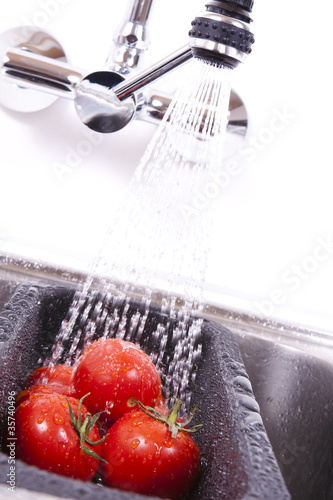 Delicious ripe tomatoes are washed off.