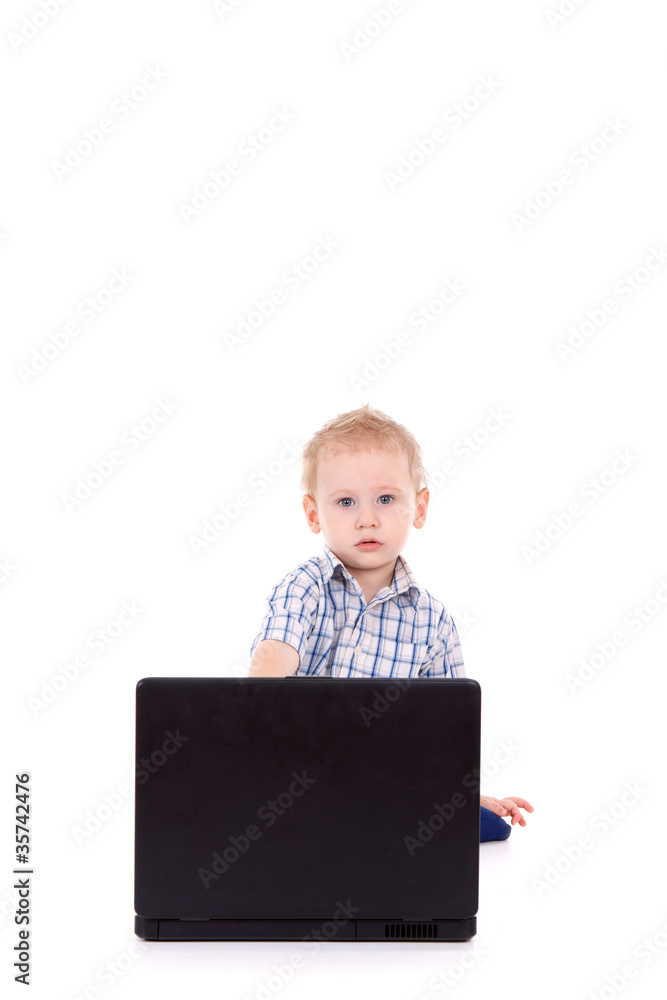 Little boy sitting with laptop over white background Little boy sitting with laptop over white background
