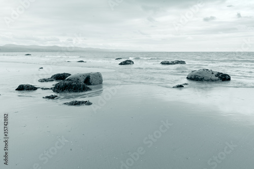 Blue toned tranquil scene at Criccieth beach