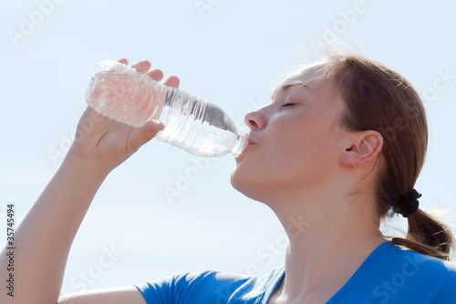 young woman drinking water from bottle