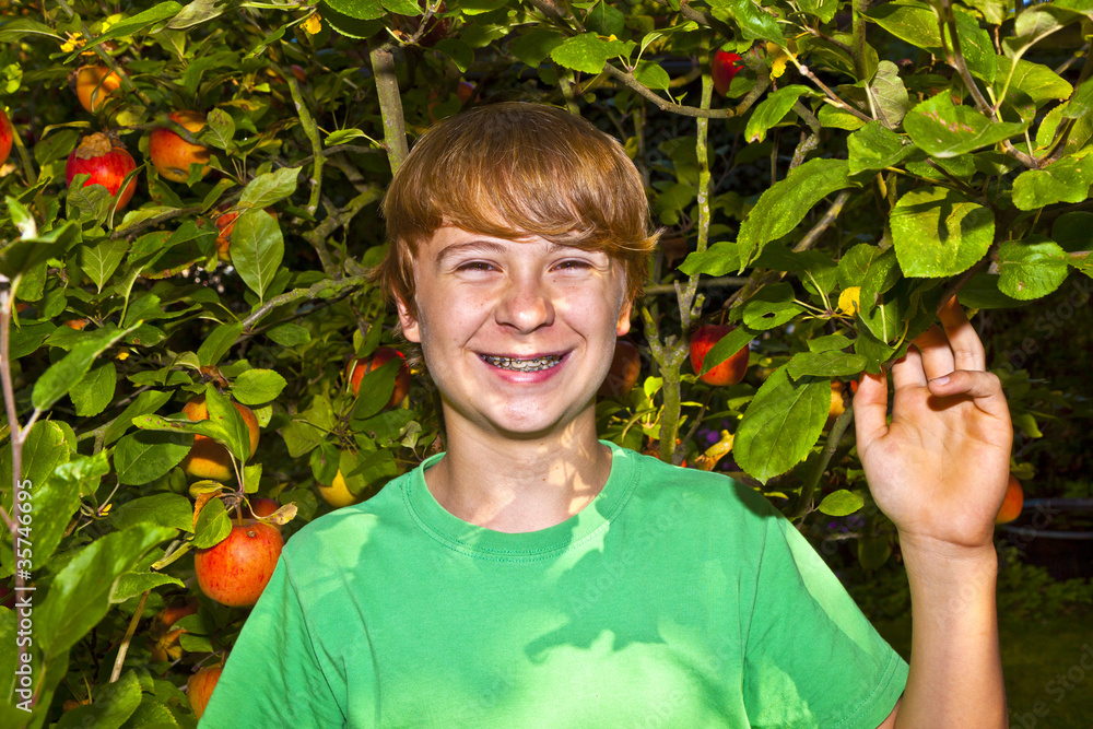 cute smart boy in the garden under the tree cute smart boy in the garden under the tree