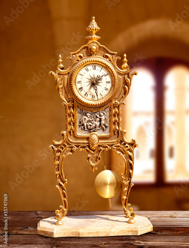 ancient vintage golden brass pendulum clock