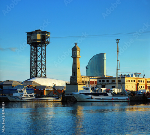 fishing ships and tower with hours per port of barcelona; Port