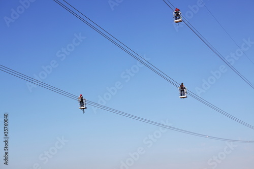 Overhead power line during construction, and workers team