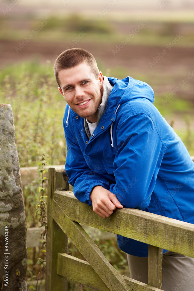 Fototapeta premium Man leaning on country gate