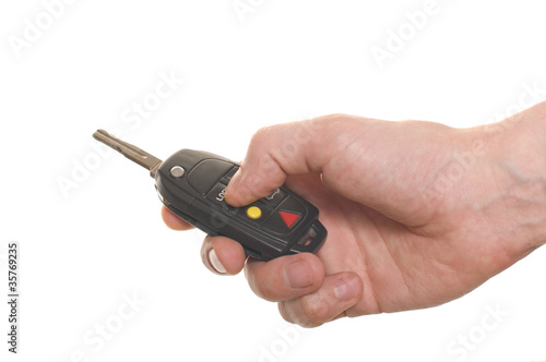 men's hand with a car's key isolated over white