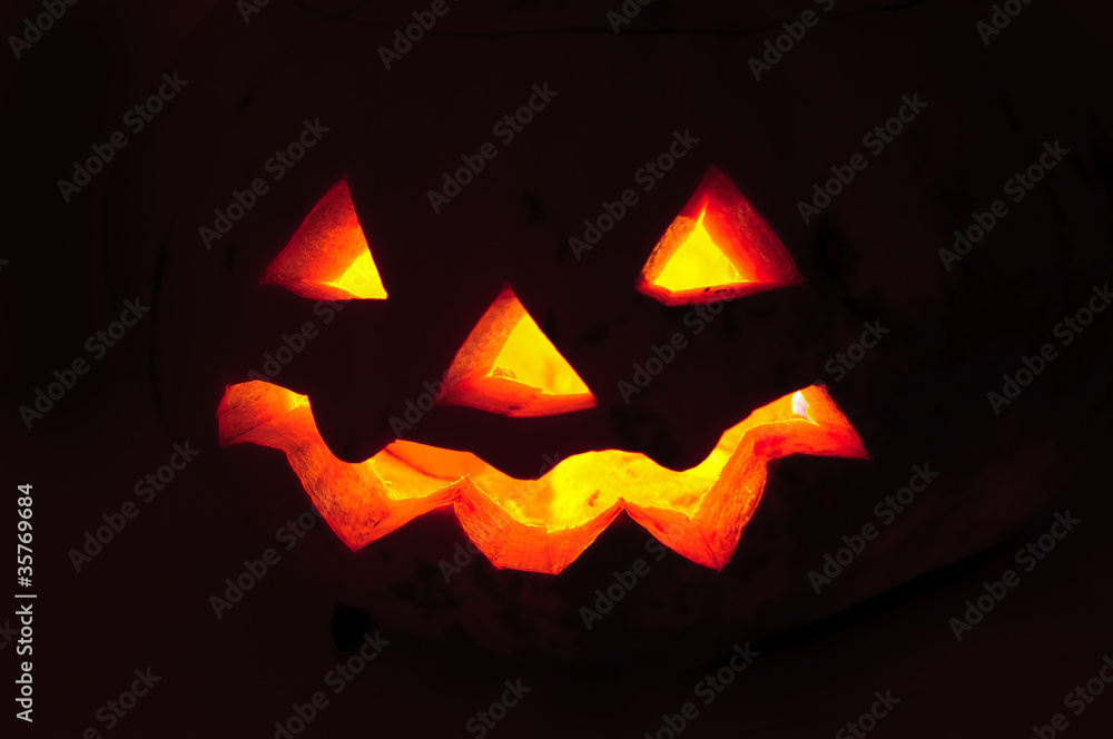 Fototapeta premium Glowing pumpkin with a candle inside