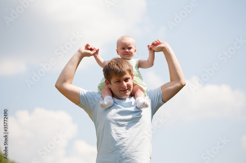 father and daughter under blue sky