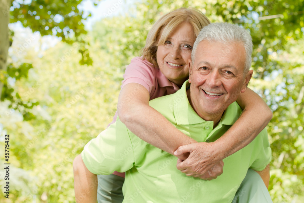 happy senior man giving piggyback ride happy senior man giving piggyback ride