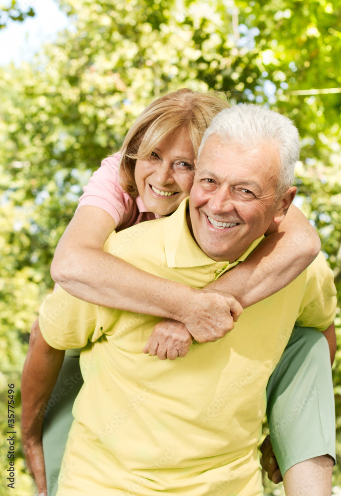 happy senior man giving piggyback ride