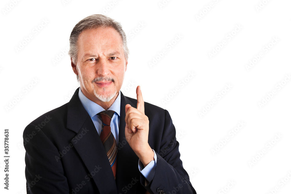 Smiling businessman pointing up Smiling businessman pointing up