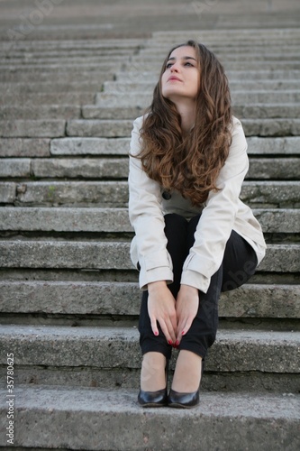 Young beautiful girl sitting on stairs