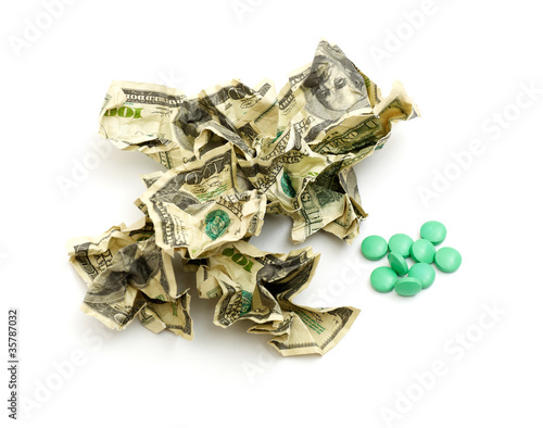 Crumpled american money and pills