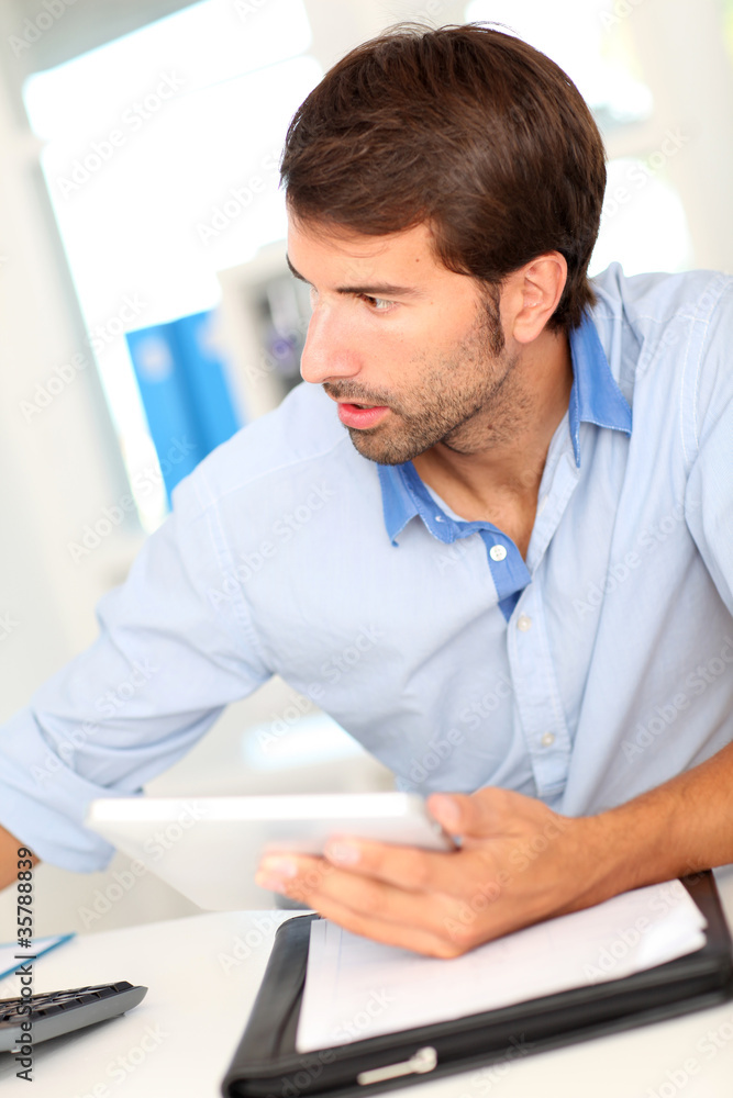 Office worker using tablet at work Office worker using tablet at work