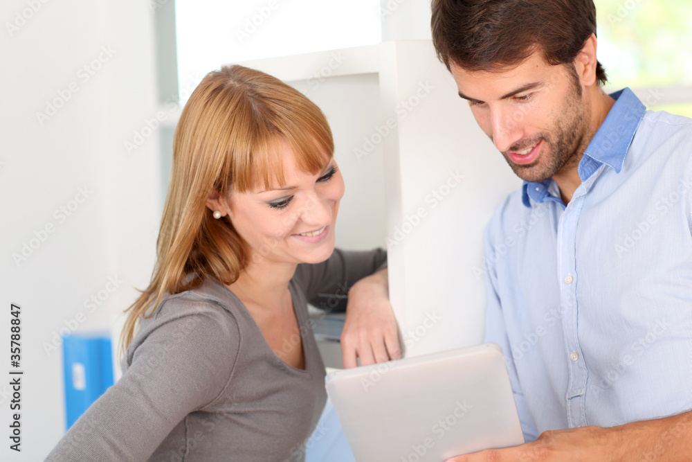 Office workers websurfing on tablet Office workers websurfing on tablet