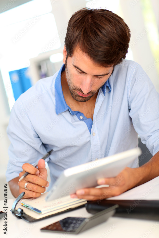 Portrait of office worker using electronic tablet Portrait of office worker using electronic tablet