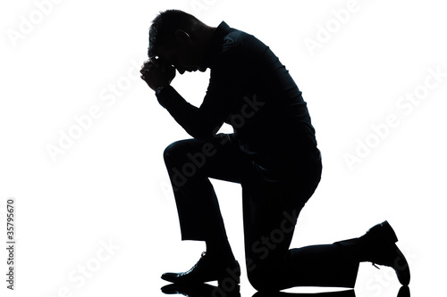 Fototapeta silhouette man kneeling sadness praying full length