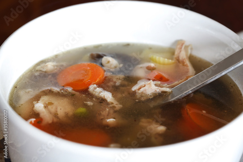 Chicken soup with vegetables close-up