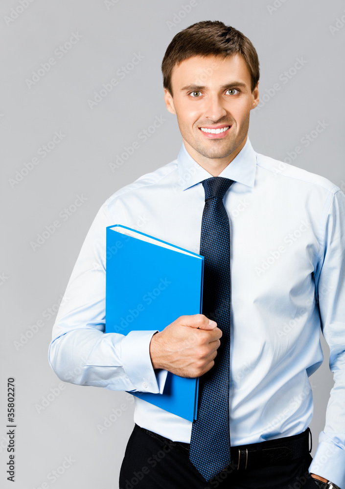 Portrait of business man with folder, over gray Portrait of business man with folder, over gray