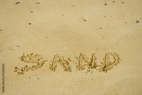 the word sand written in sand