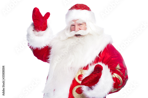 Santa Claus pointing his hand isolated over white.