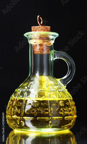 olive oil and olives on yellow background