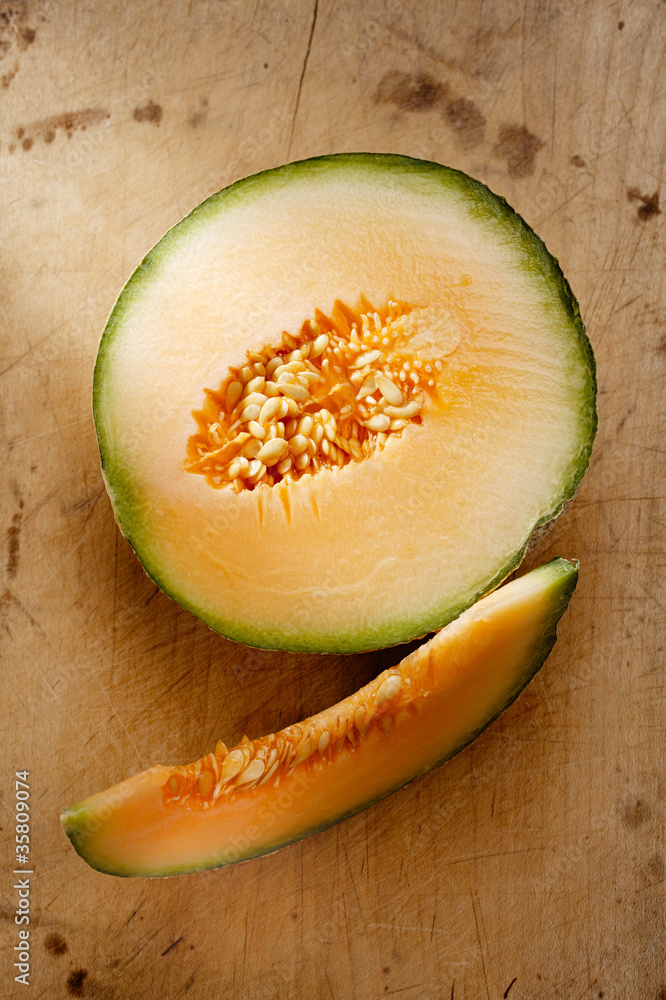 custom made wallpaper toronto digitalCantaloupe melon slice and one half on wooden table