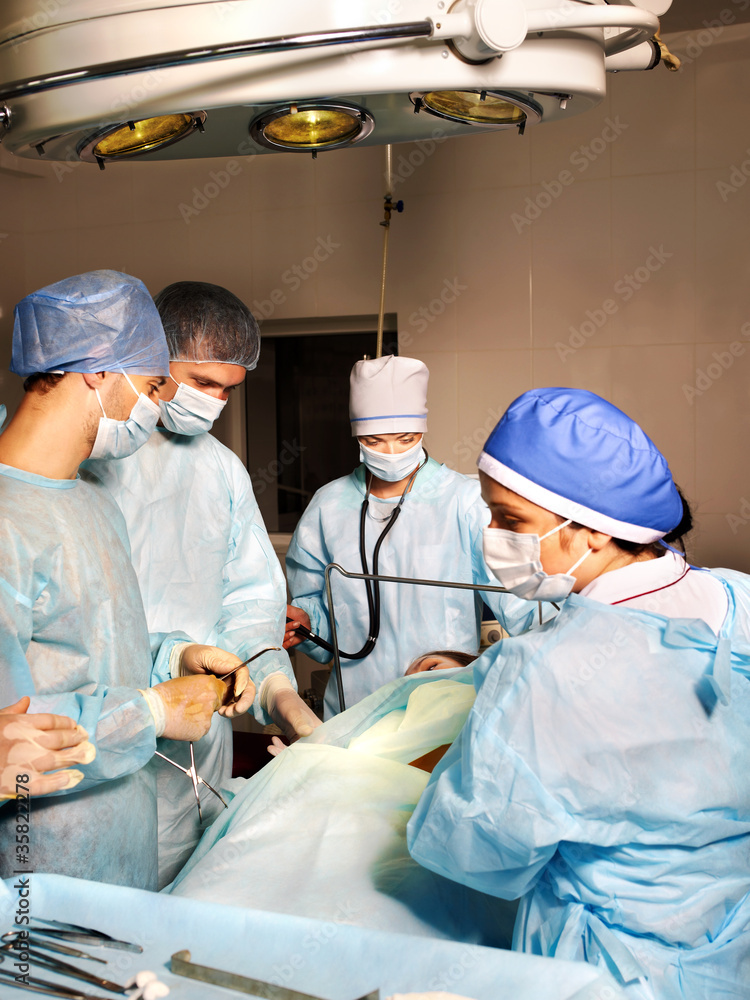 Group of surgeon looking at patient. Group of surgeon looking at patient.