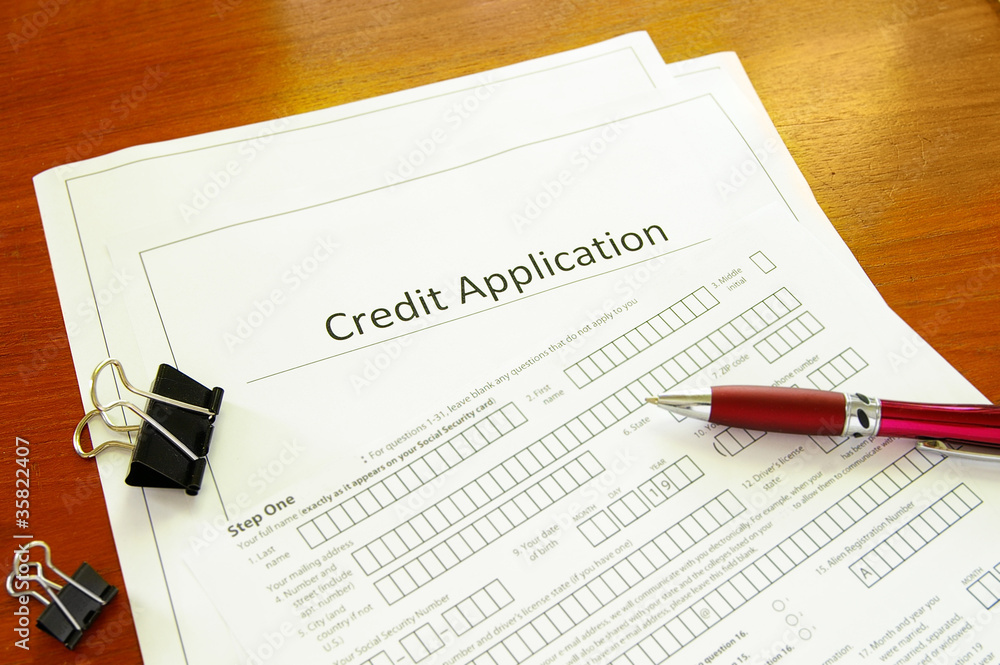 Blank credit application form with pen and clips Blank credit application form with pen and clips