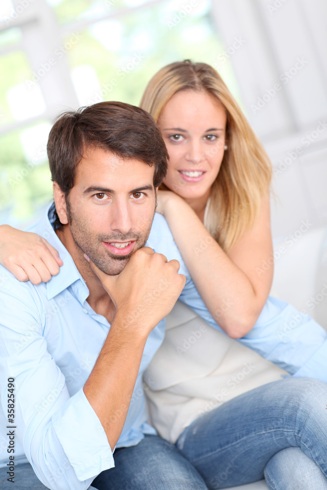 Young couple relaxing in sofa at home Young couple relaxing in sofa at home