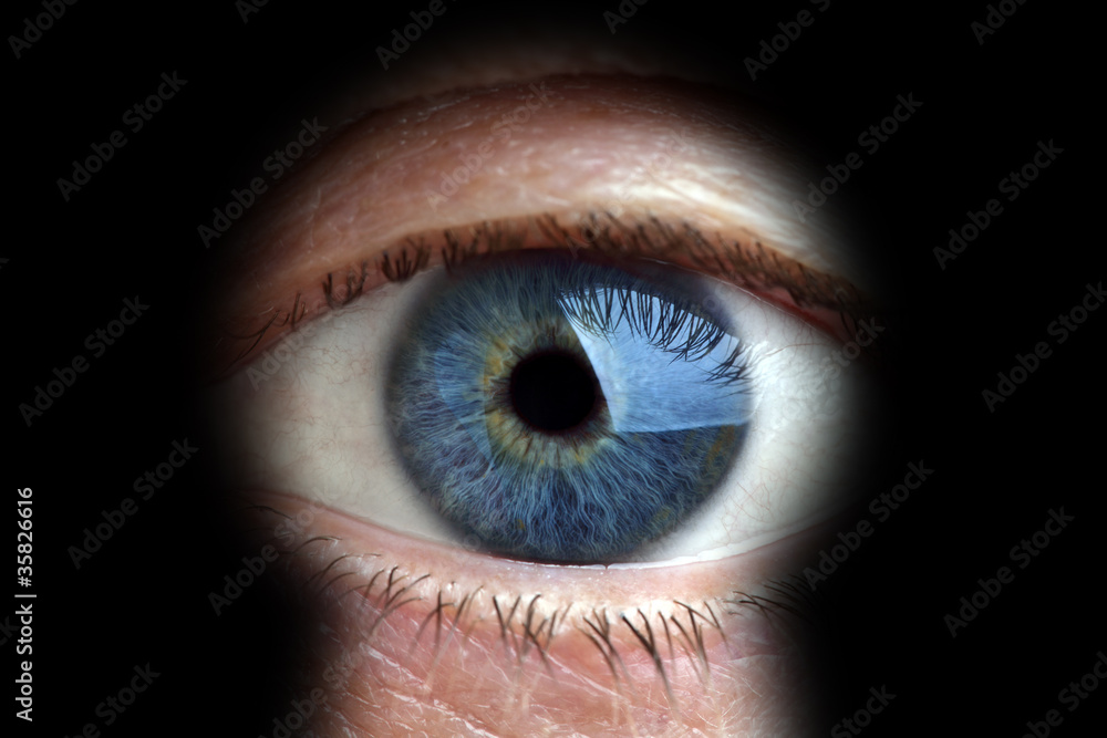 Man looking through keyhole Man looking through keyhole