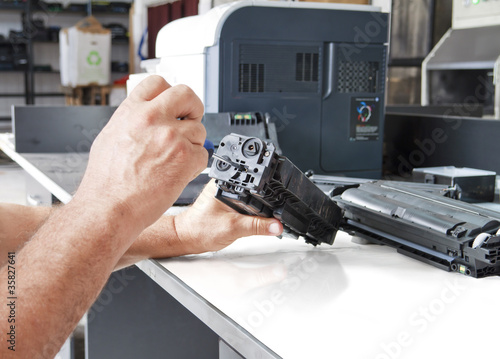 hands repairing toner cartridge photo