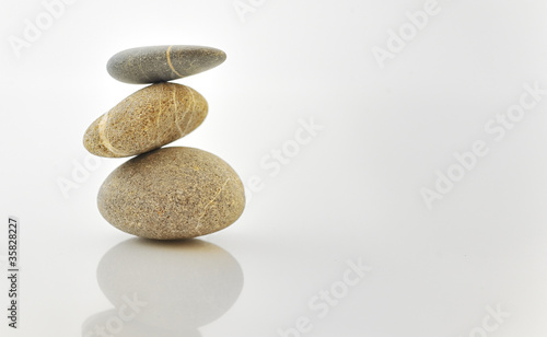 Pyramid of stones over white.