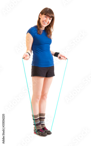 Young woman jumping on skipping rope