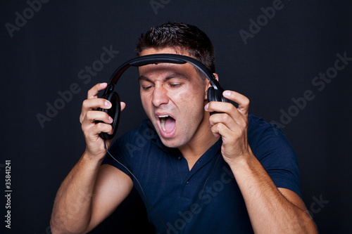 Man yelling while listening to headphones