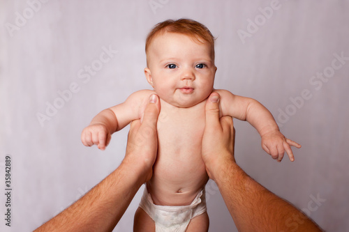 POV person holding baby with arms stretched
