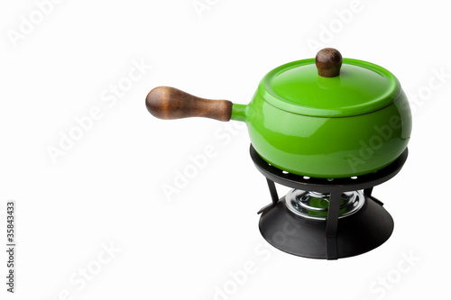 Bright green fondue pot isolated against white background