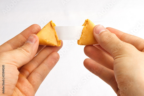 Fortune cookie being pulled apart with a blank fortune