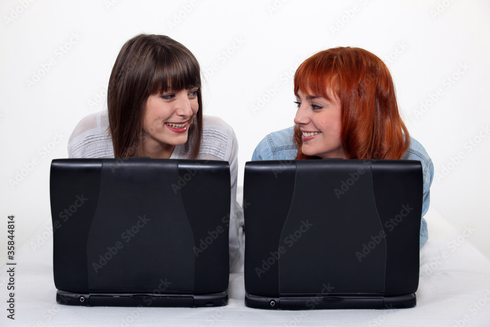 Two female friends with their laptops. Two female friends with their laptops.