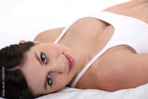 Woman lying on a bed relaxing