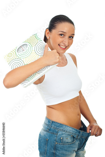 Slim woman holding scales